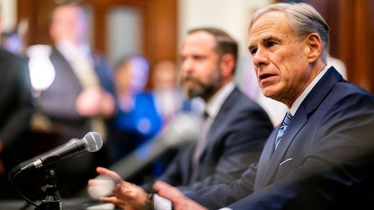 Texas Governor Greg Abbott speaking at a podium about immigration enforcement
